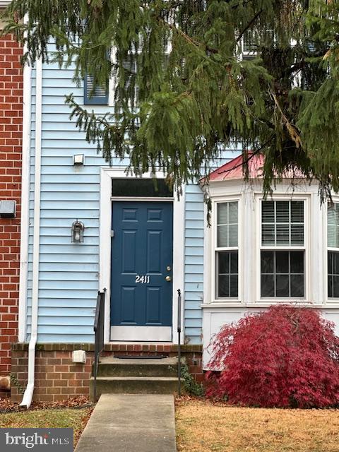 2411 Potterfield Road Windsor Mill, MD 21244 - Photo 2 of 28 a front view of a house with a garden