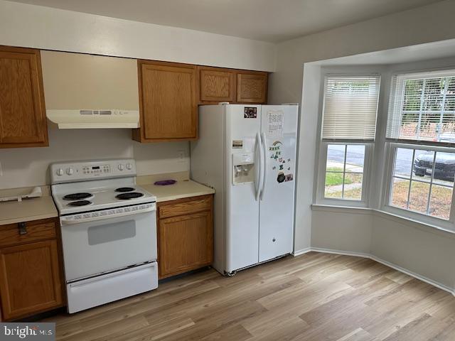 2411 Potterfield Road Windsor Mill, MD 21244 - Photo 6 of 28 a kitchen with a stove a refrigerator and a window