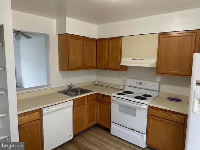 2411 Potterfield Road Windsor Mill, MD 21244 - Photo 7 of 28 a kitchen with a sink stove and cabinets