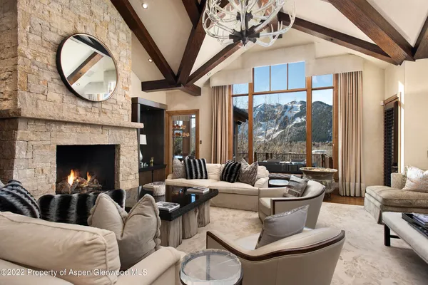 a living room with furniture a fireplace and a large window