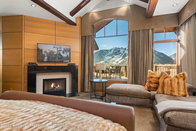 a bedroom with furniture and a fireplace