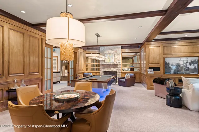 a dining room with furniture a chandelier and window
