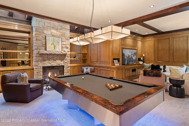 a living room with furniture a table and a fireplace