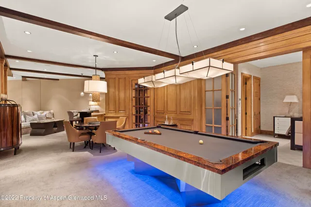 a living room with furniture a table and a large window