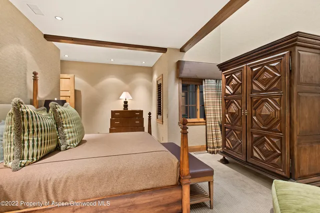 a bedroom with a bed and a mirror