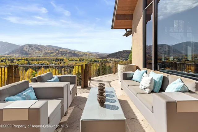 a view of a balcony with furniture and chandelier
