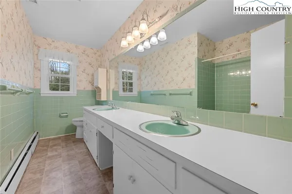 a bath room with a sink and a mirror