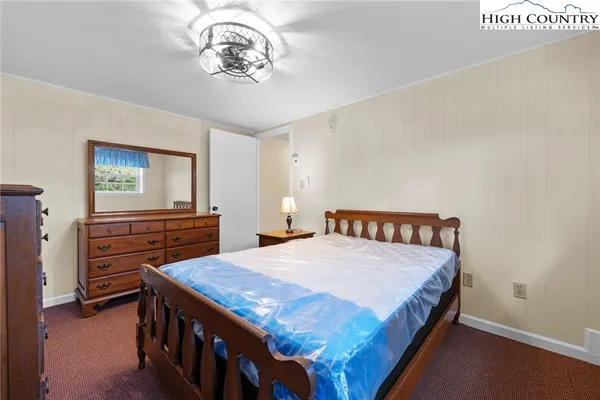 a bedroom with a bed and a chandelier
