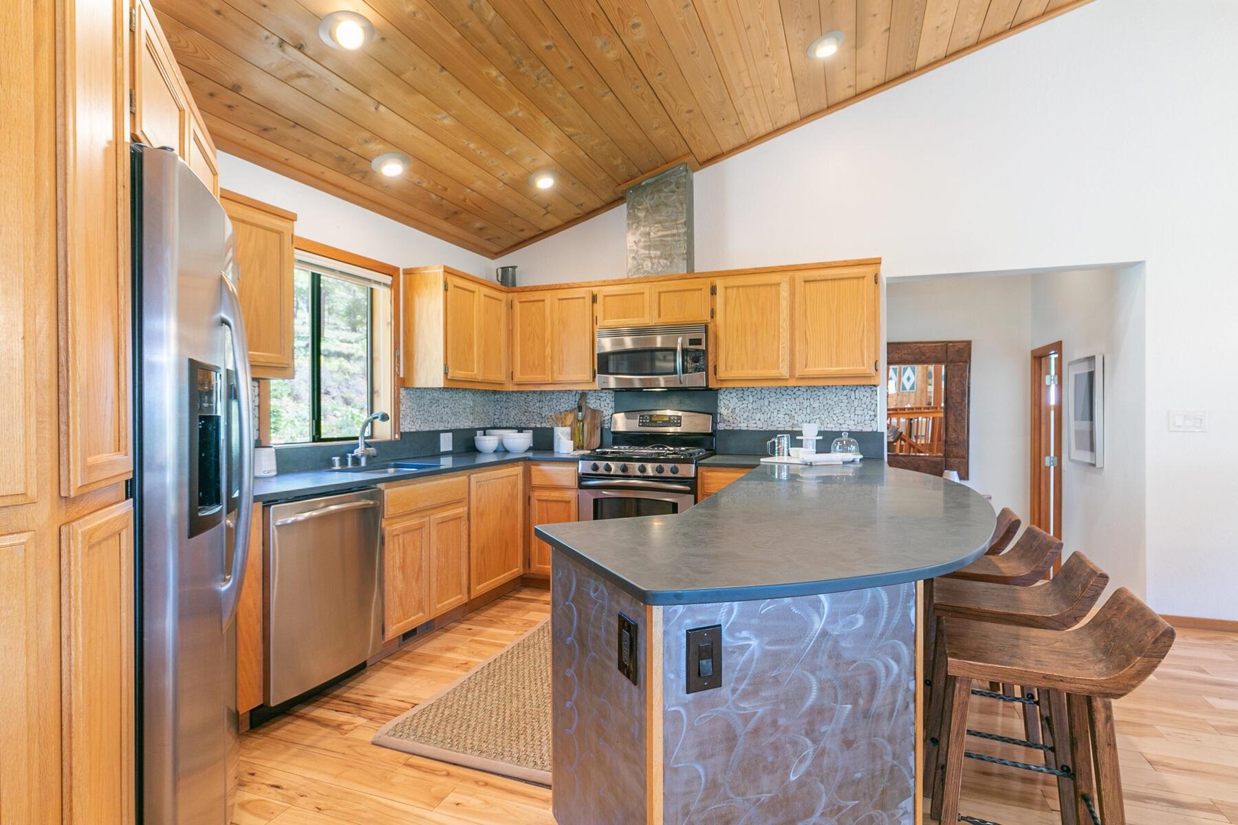 397 Skidder Trail Truckee, CA 96161 - Photo 7 of 21 a kitchen with stainless steel appliances granite countertop a sink a stove and a refrigerator