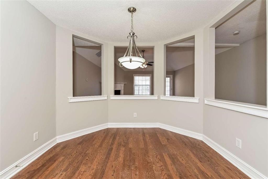 106 Emerald Lane Hampton, GA 30228 - Photo 12 of 19 a view of a room with wooden floor and chandelier