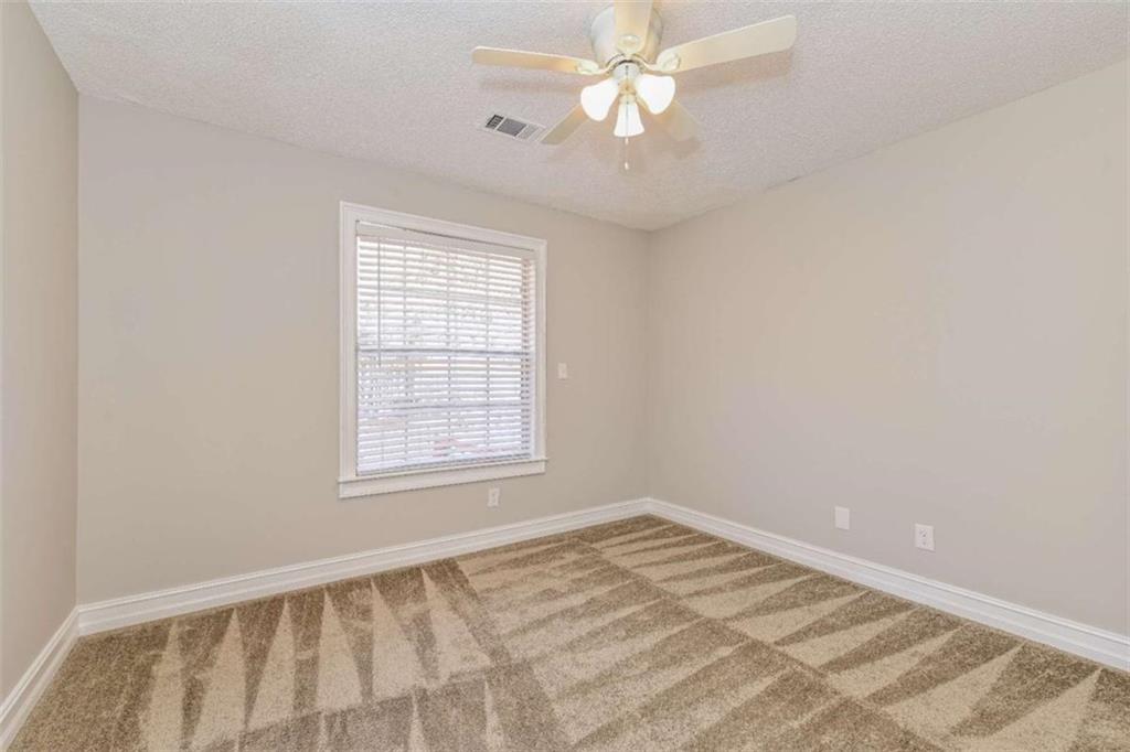 106 Emerald Lane Hampton, GA 30228 - Photo 13 of 19 a view of an empty room with a window