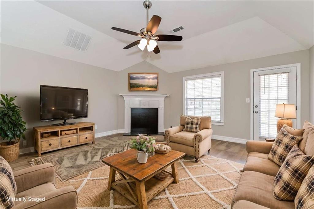 106 Emerald Lane Hampton, GA 30228 - Photo 3 of 19 a living room with furniture a flat screen tv and a fireplace