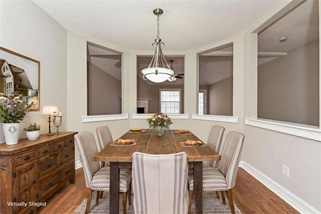 106 Emerald Lane Hampton, GA 30228 - Photo 5 of 19 a dining room with furniture a chandelier and wooden floor