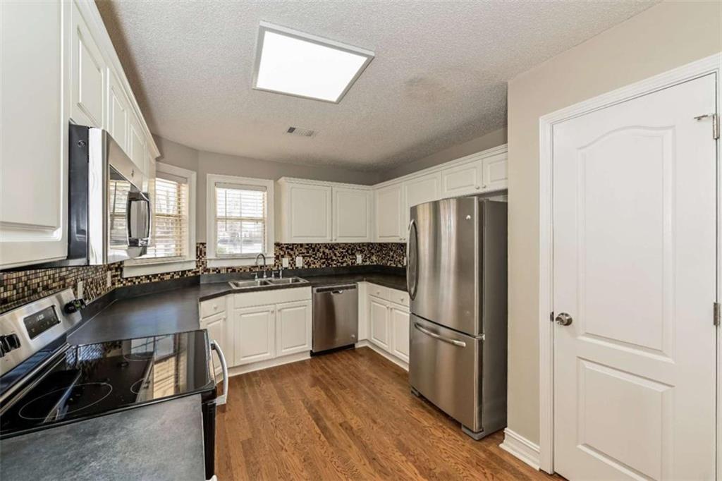 106 Emerald Lane Hampton, GA 30228 - Photo 8 of 19 a kitchen with stainless steel appliances a refrigerator and wooden cabinets