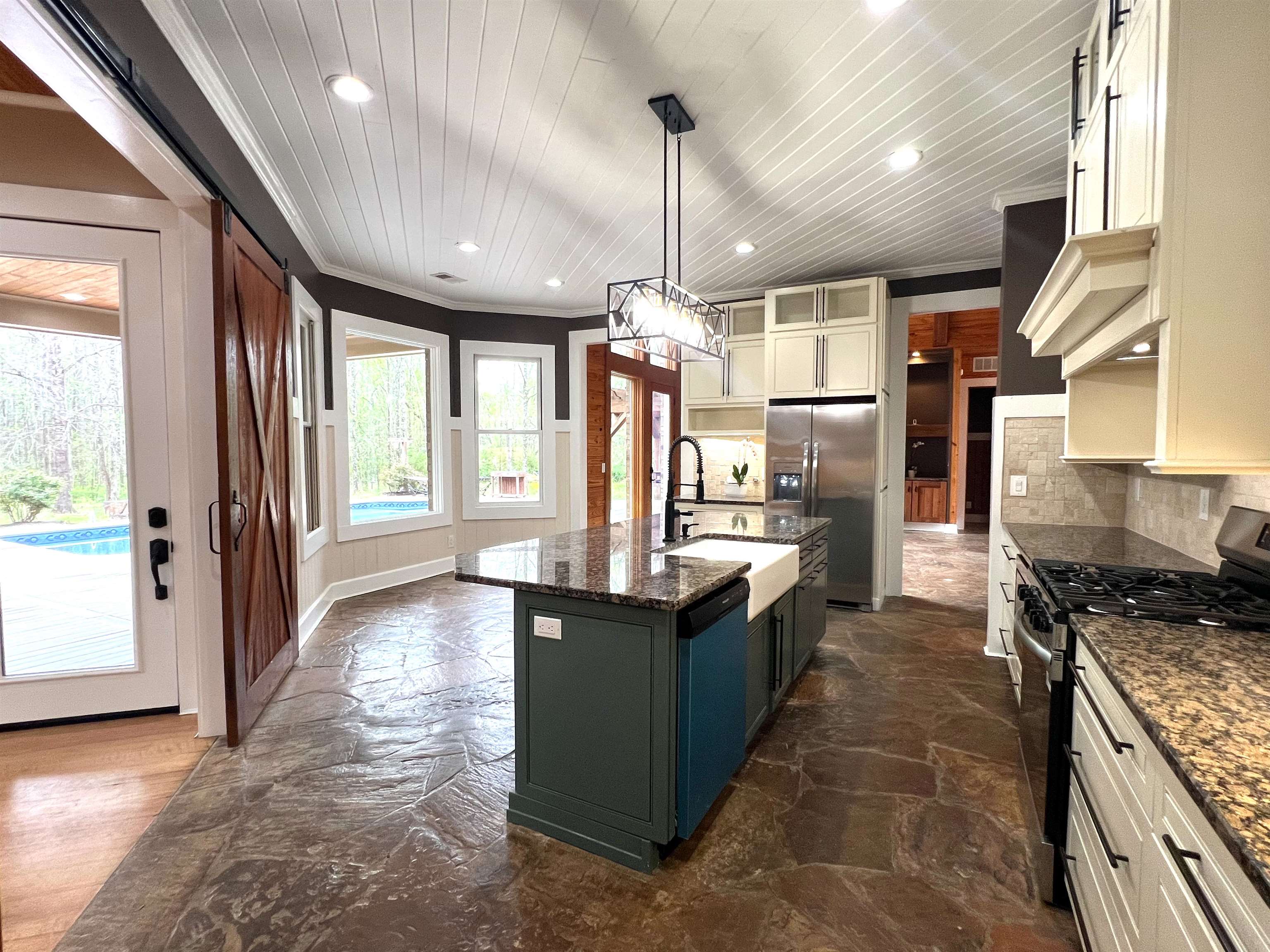 9490 Highway 196 Collierville, TN 38017 - Photo 13 of 40 Dual tone kitchen with dual tone cabinets, stainless steel appliances, pendant lighting, dark stone counters, and ornamental molding