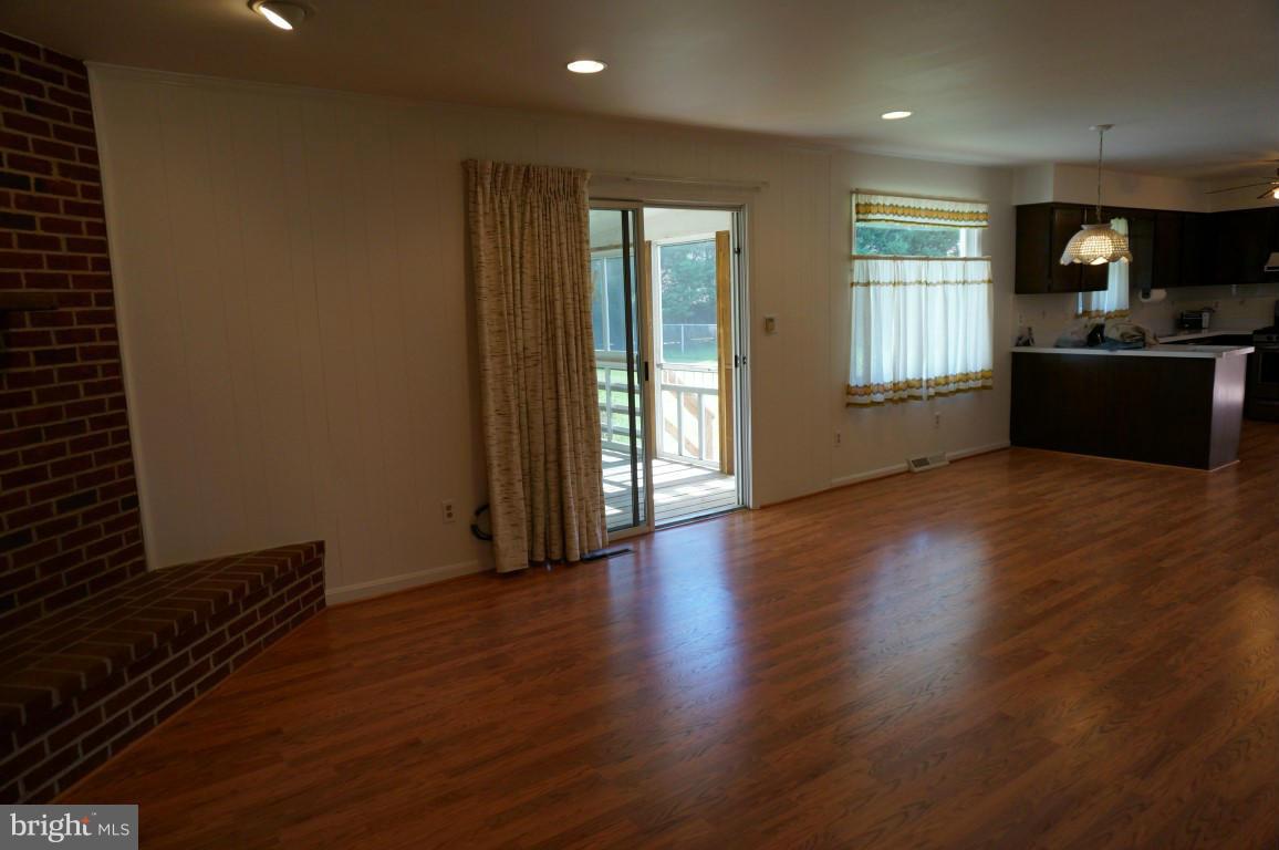 8611 McDaniel Road Baltimore, MD 21237 - Photo 14 of 21 a view of an empty room with wooden floor and a window