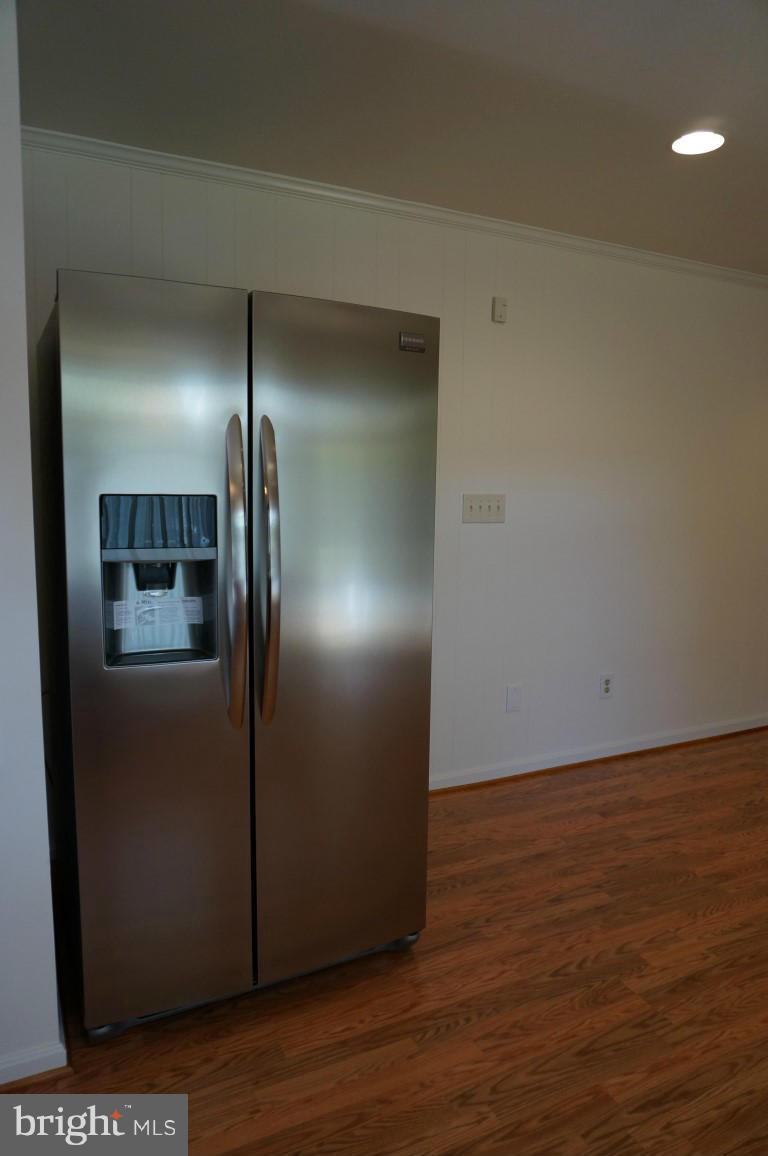 8611 McDaniel Road Baltimore, MD 21237 - Photo 17 of 21 a view of empty room with wooden floor