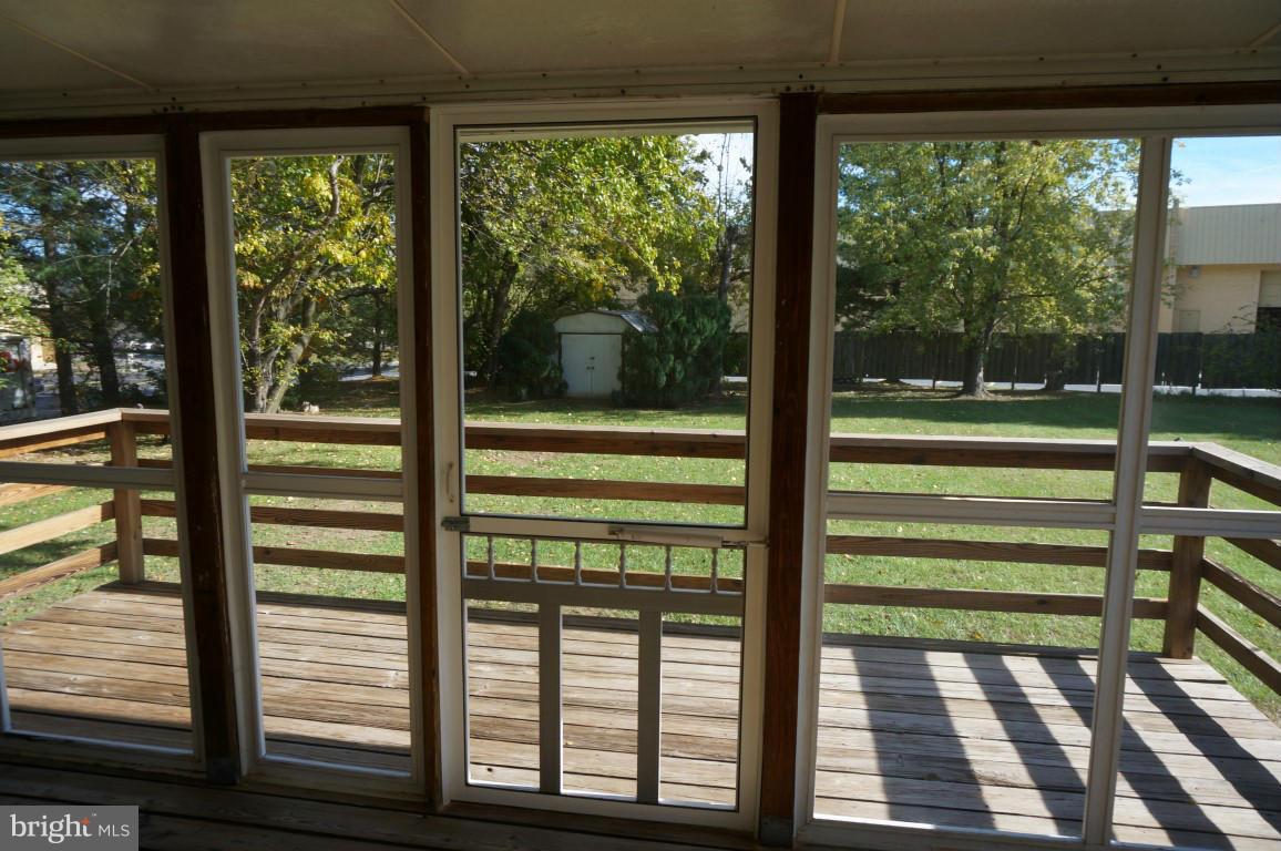 8611 McDaniel Road Baltimore, MD 21237 - Photo 21 of 21 a view of a porch with a floor to ceiling window wooden fence