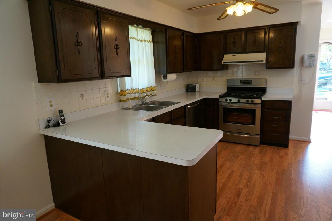 8611 McDaniel Road Baltimore, MD 21237 - Photo 5 of 21 a kitchen with a sink a stove and cabinets