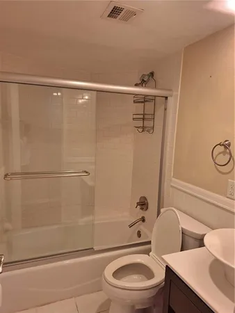 a bathroom with a toilet a sink and shower