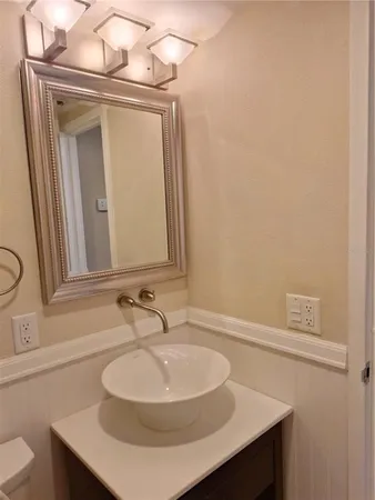 a bathroom with a sink a mirror and a toilet