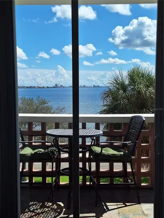a view of a chairs and table in the balcony
