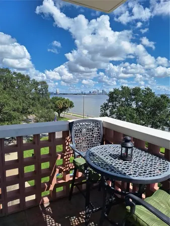 a view of a balcony with two chairs and a table