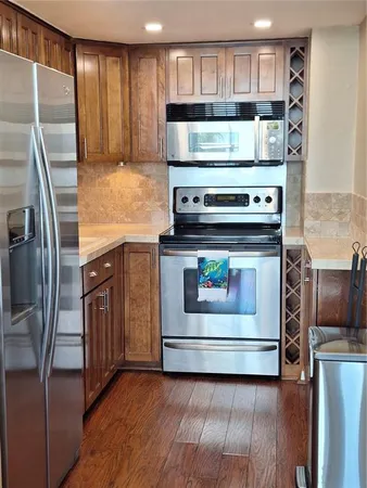 a kitchen with a stove and a refrigerator
