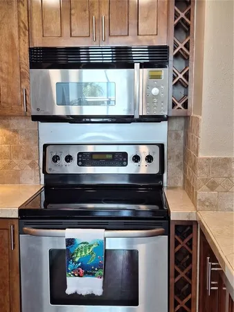 a stove top oven sitting inside of a kitchen