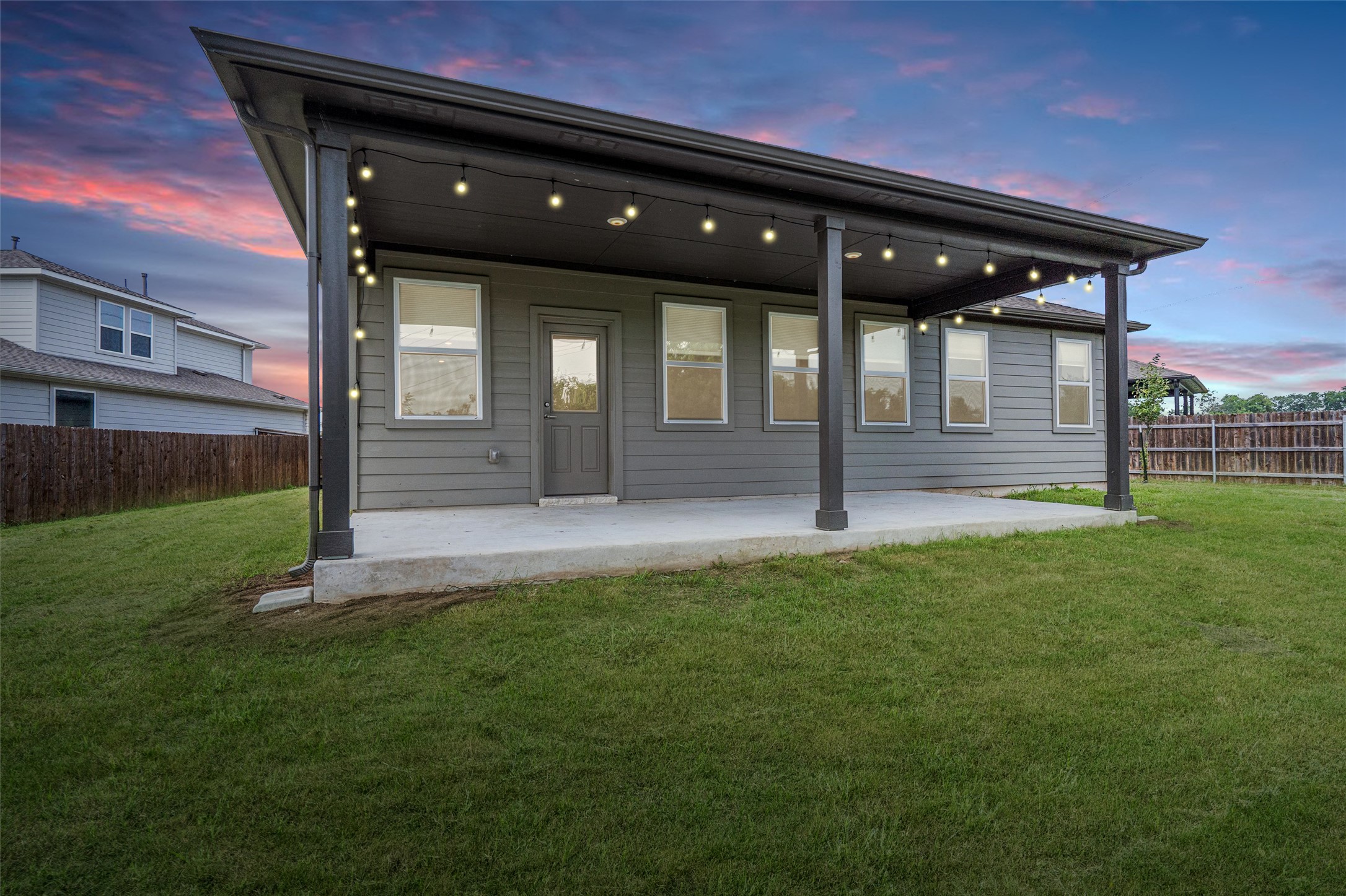 104 Stinchcomb Road Hutto, TX 78634 - Photo 31 of 40 Step outside to enjoy a large covered patio, fruit trees, an oversized backyard, and a peaceful greenbelt backdrop that makes the outdoor space feel both private and rare.