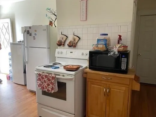 a kitchen with stainless steel appliances granite countertop a refrigerator and a stove