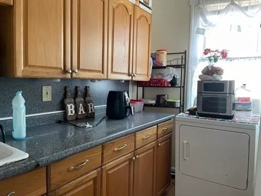 a kitchen with stainless steel appliances granite countertop a sink and a white cabinets