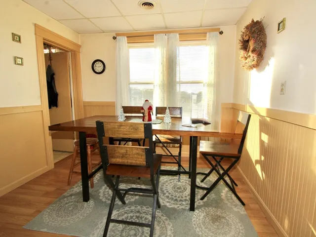 a view of a dining room with furniture and window