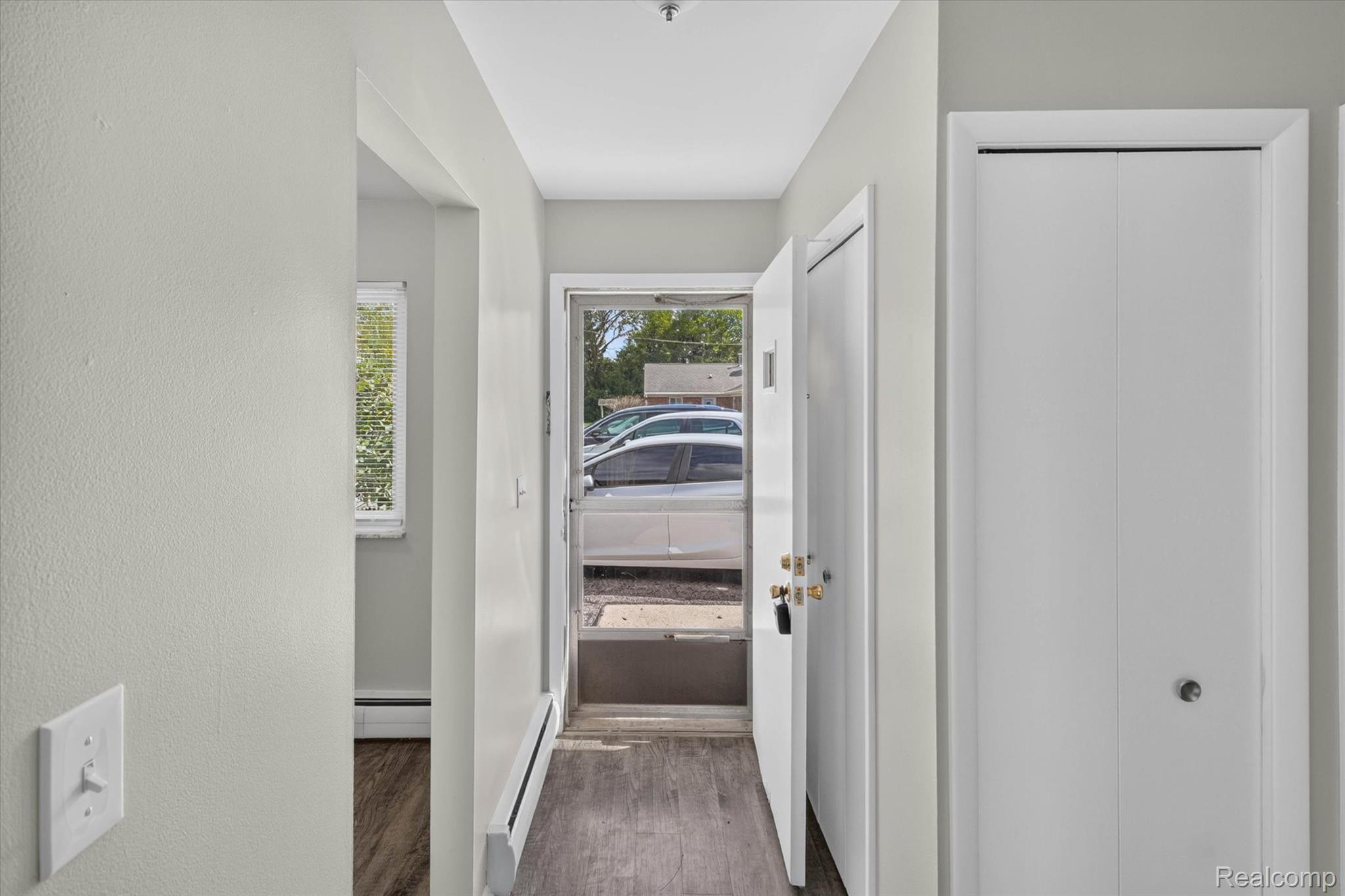 22000 Beck Road, Unit 101 Northville, MI 48167 - Photo 4 of 20 Wood-finish flooring, white bi-fold closet doors, and light-toned walls