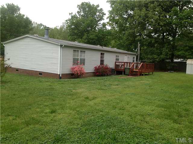 88 Flat River Church Road Roxboro, NC 27573 - Photo 2 of 17 a view of a house with a yard and garage