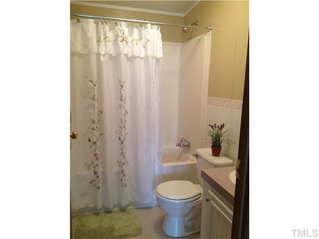 88 Flat River Church Road Roxboro, NC 27573 - Photo 9 of 17 a bathroom with a toilet a sink and a shower