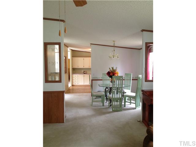 88 Flat River Church Road Roxboro, NC 27573 - Photo 10 of 17 a dining room with furniture and a potted plant