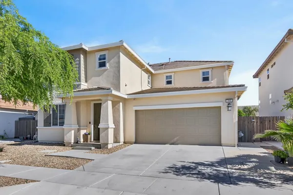 a front view of a house with a garage