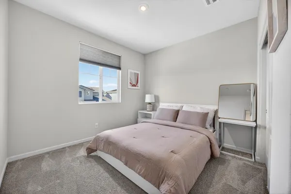 a bedroom with a bed and a window