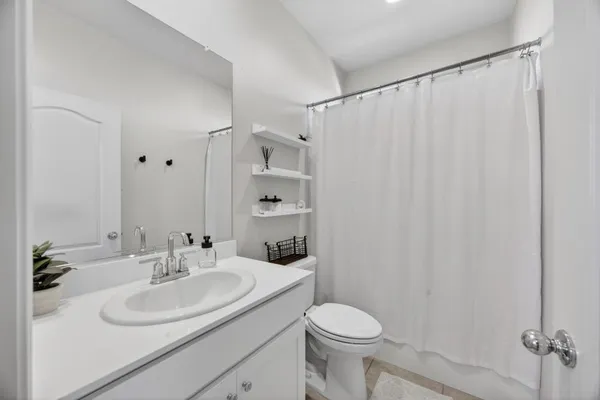 a bathroom with a double vanity sink mirror double and shower