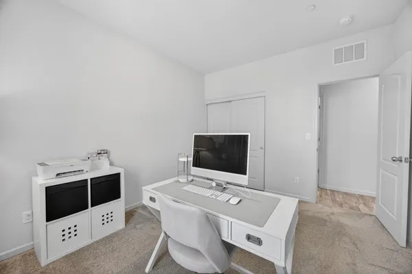 a view of a dining room with furniture and window