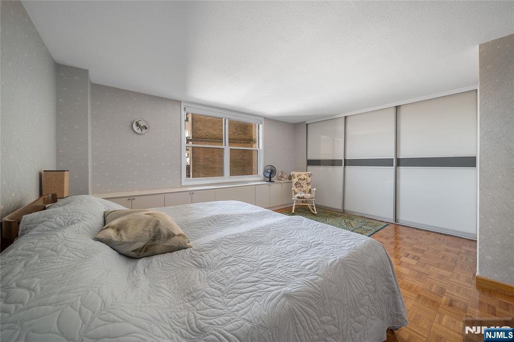 2200 North Central Road, Unit 6H Fort Lee, NJ 07024 - Photo 12 of 18 a bedroom with a bed and a window