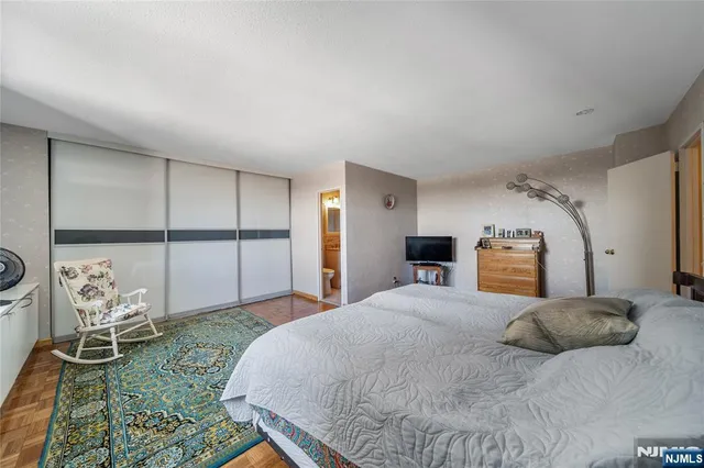 a bedroom with a large bed and a window