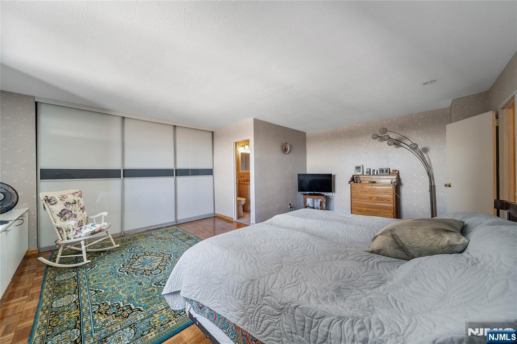 2200 North Central Road, Unit 6H Fort Lee, NJ 07024 - Photo 13 of 18 a bedroom with a large bed and a window