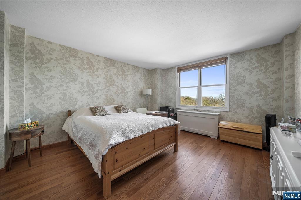 2200 North Central Road, Unit 6H Fort Lee, NJ 07024 - Photo 16 of 18 a bedroom with a bed and a desk