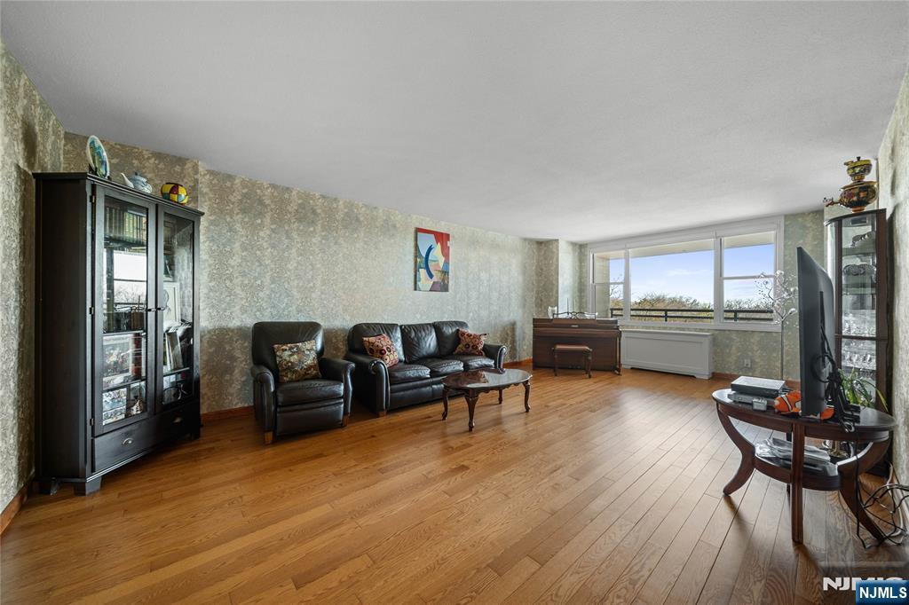 2200 North Central Road, Unit 6H Fort Lee, NJ 07024 - Photo 2 of 18 a living room with furniture and a wooden floor