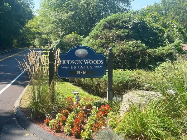 a sign that is sitting on a brick wall