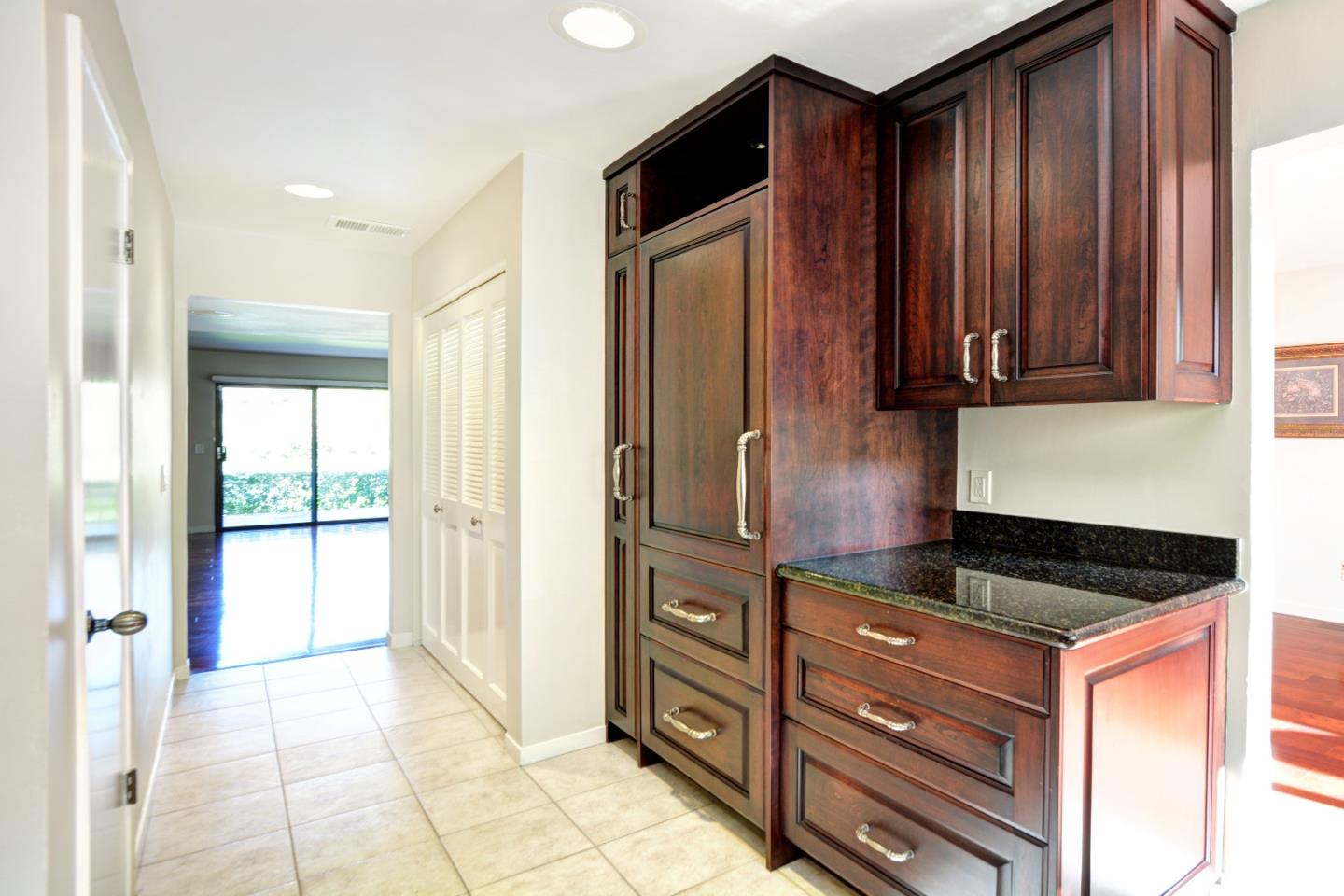 3850 Rio Road, Unit 40 Carmel, CA 93923 - Photo 11 of 28 a kitchen with granite countertop wooden cabinets and a stove top oven