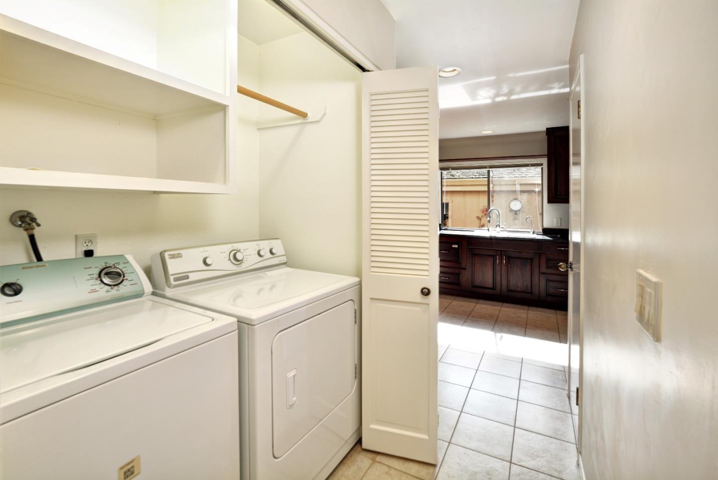 3850 Rio Road, Unit 40 Carmel, CA 93923 - Photo 13 of 28 a view of washer and dryer with bathroom in the background