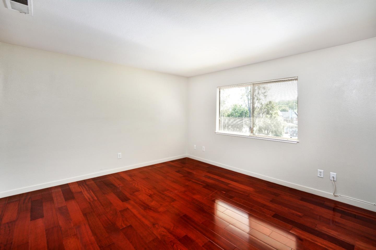 3850 Rio Road, Unit 40 Carmel, CA 93923 - Photo 16 of 28 an empty room with wooden floor and windows